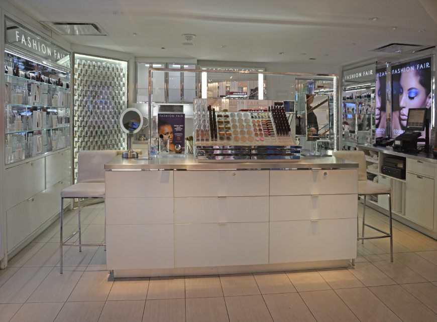 gallery image of custom retail interior in-store display make-up boutique project featuring custom color temperatures, LED make-up display counters with storage drawers, custom counter display fixtures, and LED display walls for make-up for Fashion Fair at Macy's by Visual Millwork