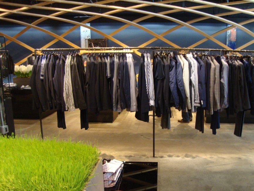 gallery image of custom retail interior clothing store featuring custom clothing racks for Hugo Boss by VIsual Millwork