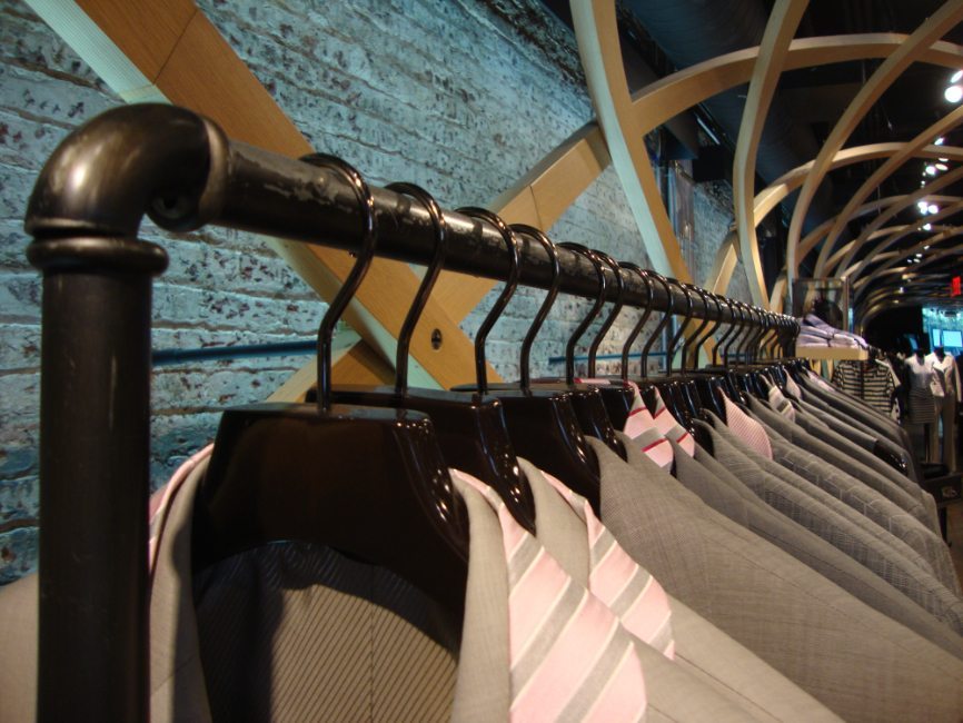 gallery image of custom retail interior clothing store featuring custom suit rack for Hugo Boss by Visual Millwork