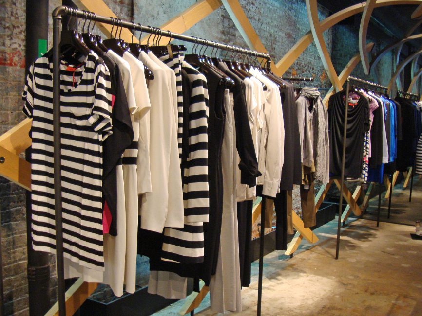 gallery image of custom retail interior clothing store featuring custom clothing rack for Hugo Boss by Visual Millwork