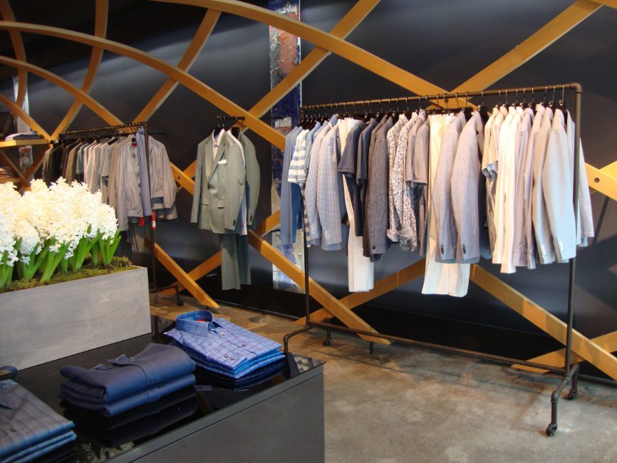 gallery image of custom retail interior clothing store featuring custom shirt display counter, custom clothing rack,  and custom suit rack for Hugo Boss by Visual Millwork