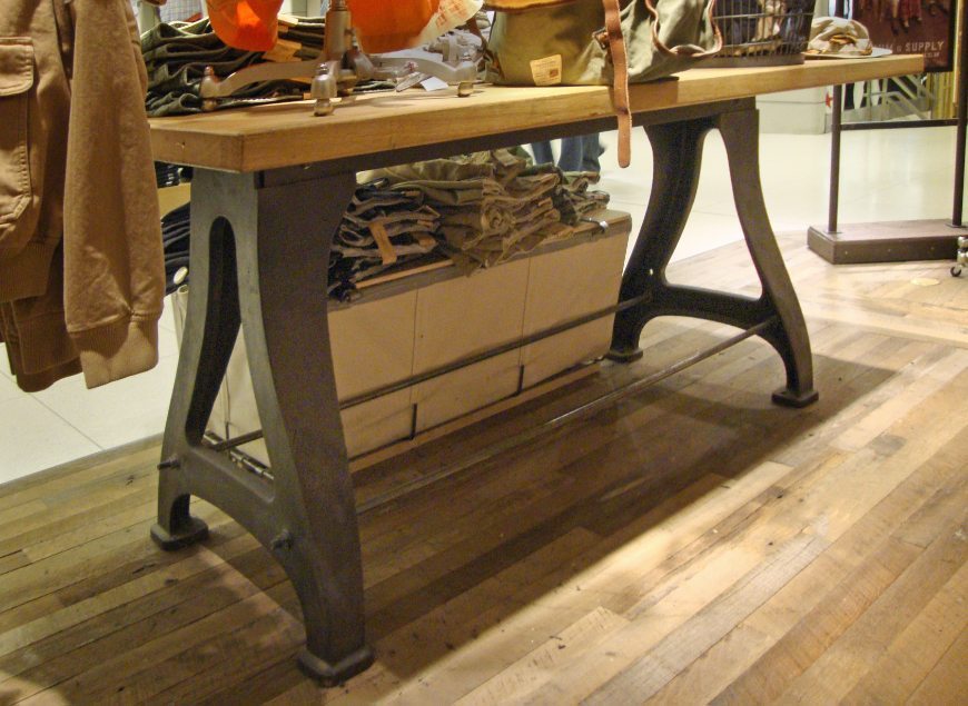image of custom retail interior project for Ralph Lauren Denim & Supply featuring custom wood and metal display table by Visual Millwork
