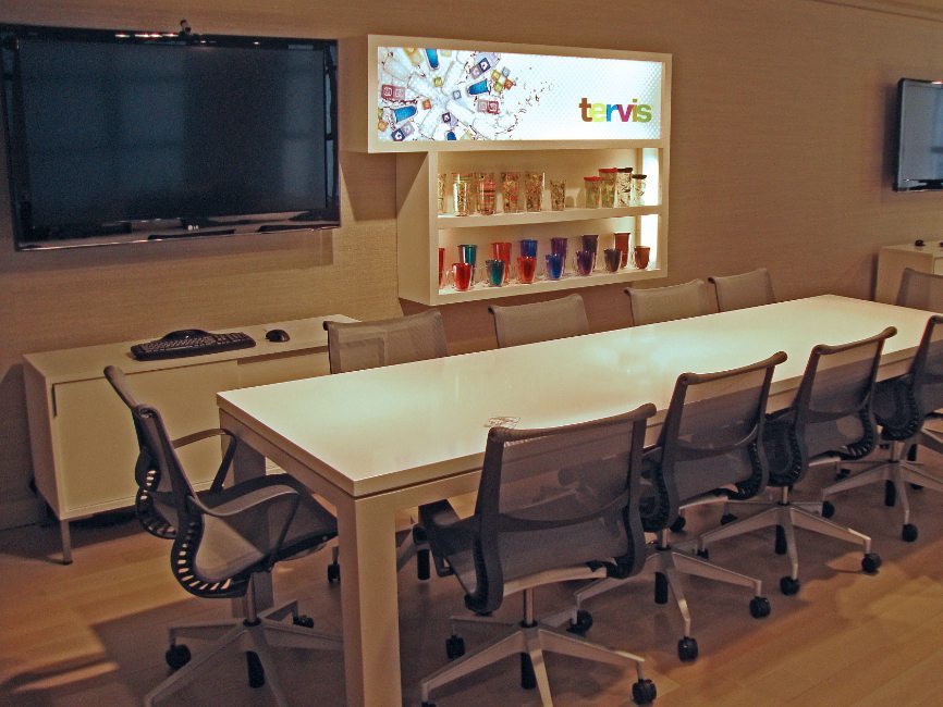 image of custom corporate interior project for Tervis Design Center featuring custom work table, custom illuminated wall displays and cabinets and custom base cabinets by Visual Millwork