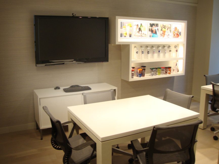 image of custom corporate interior project for Tervis Design Center featuring custom work tables, custom base cabinets, and custom illuminated wall displays and cabinets by Visual Millwork