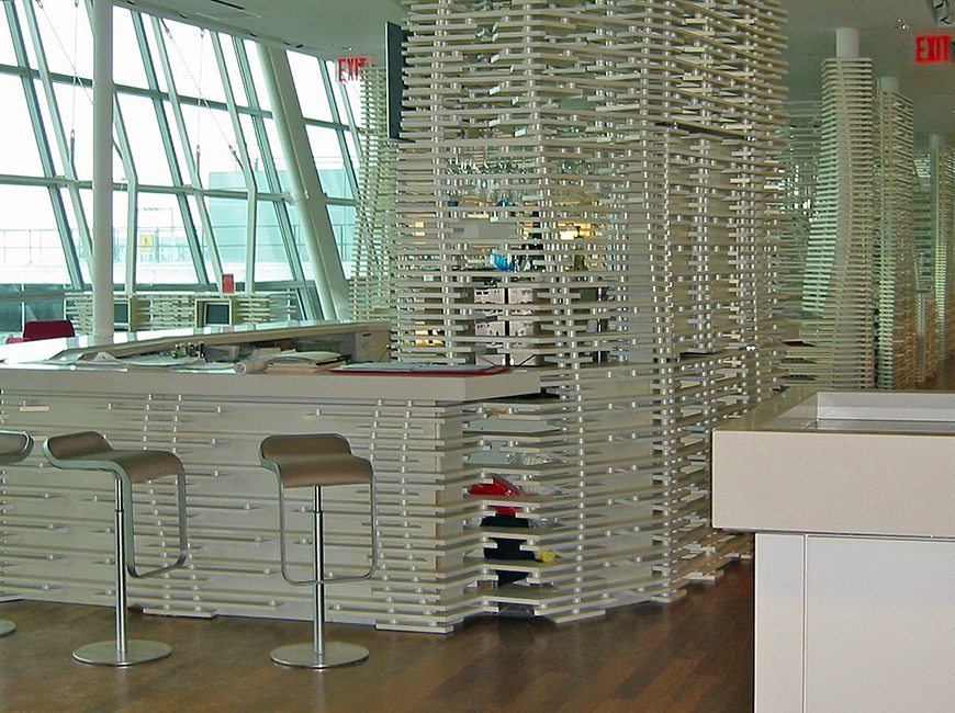 image of commercial interior project featuring custom counters, counter stools, and lattice woodwork for Virgin Atlantic  Lounge at JFK by Visual Millwork