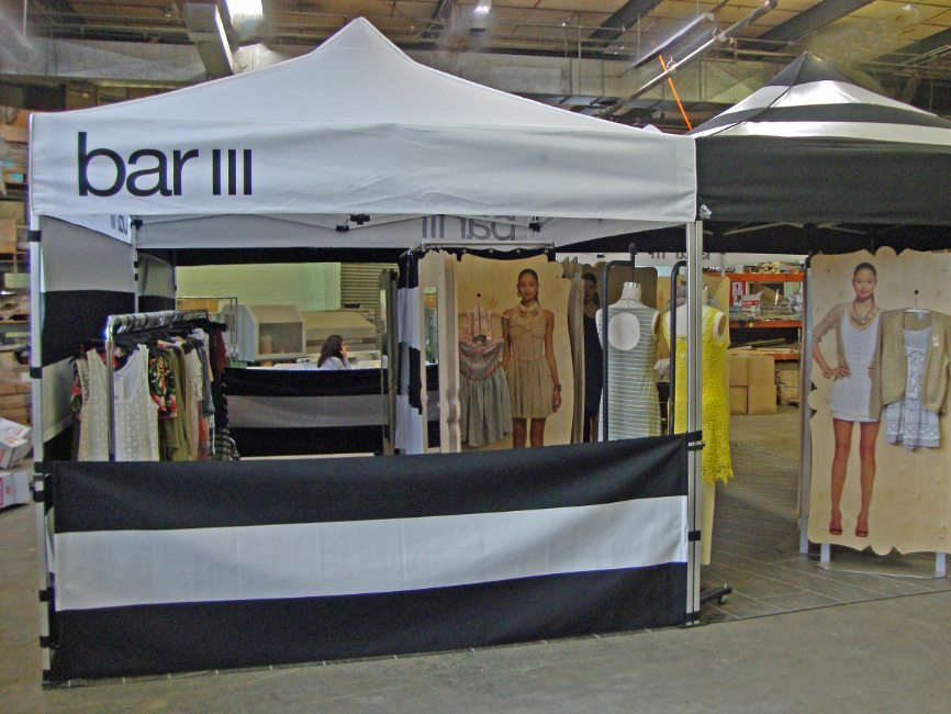gallery image of custom retail interior mall pop up display project featuring movable clothing racks and portable POS cash wrap fro bar III fabricated and installed by Visual Millwork