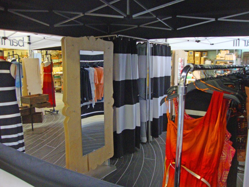 gallery image of custom retail interior pop up display project featuring movable dressing rooms for bar III fabricated and installed by Visual Millwork